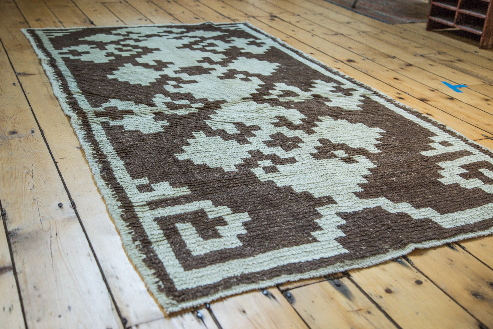 Vintage Tulu rug displaying shaggy pale ivory and charcoal triple geometric medallions.